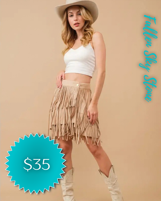 Model wearing Blue B beige faux suede fringe wrap skirt
